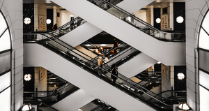 people on an escalator in a large commercial building